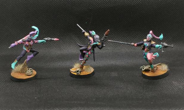 Three painted harlequins