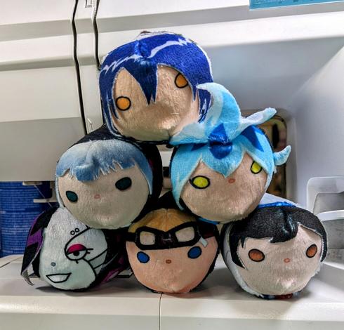 a stack of six plush precariously balanced in a sewing machine