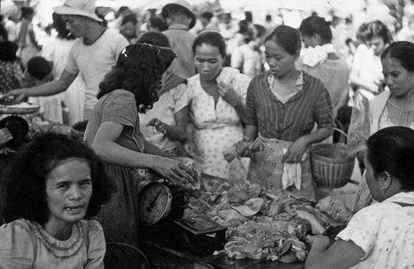 women buying meat at a public market