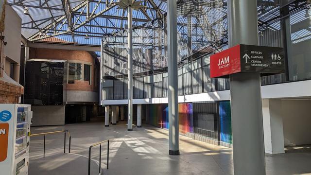 the steel and glass additions to an old factory that turn it into a mall are bereft of colourful signs and interesting little food stalls.