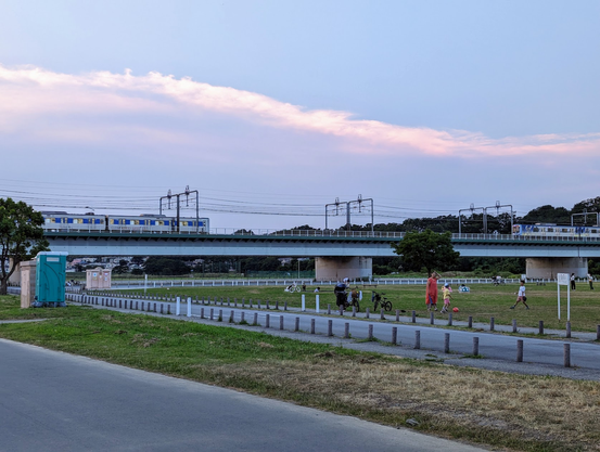 Two trains approaching on a train bridge.