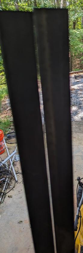 Two pieces of square tube steel side-by-side. One is not straight as shown by the gap in the middle but not the end.
