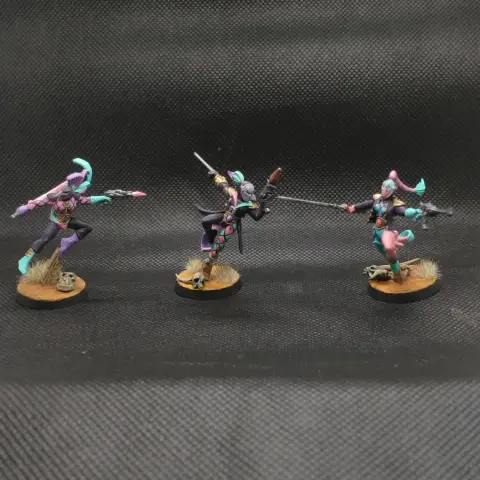 Three harlequin troupe members