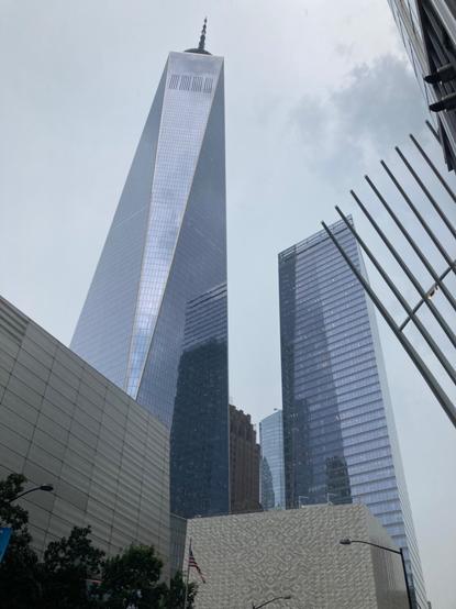 A shot up at WTC & 7WTC (World Trade Center 1, 7) with the tips of the Westfield shopping mall visible in frame. In the foreground are the new performing arts center (the cube), & the 9/11 museum bottom left.