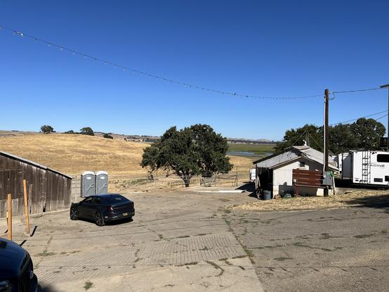 View from outside the  barn, overlooking a marsh with rolling hills in the background