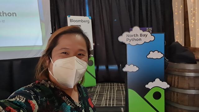 Selfie of myself in front of North Bay Python's speaker stage