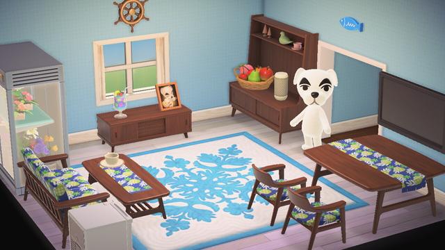 Animal Crossing: New Horizons screenshot. Happy Home Paradise setup of K.K. Slider's vacation home. The room has light blue wallpaper and white birch flooring with a blue Hawaiian print rug. The room is filled with Nordic furniture. The shot is taken from above and K.K. can be seen looking up from the doorway.