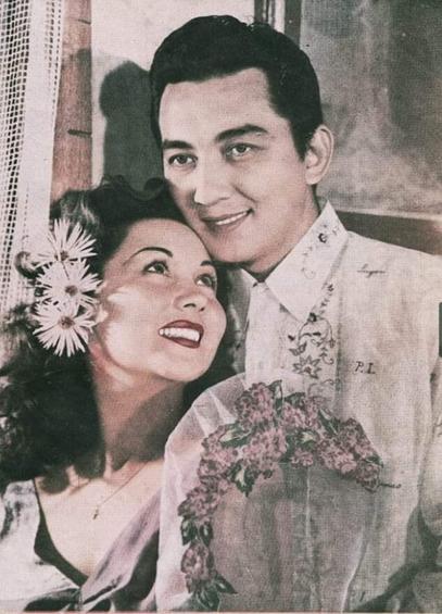 a man and a woman posing for a photo, with the woman looking at her partner