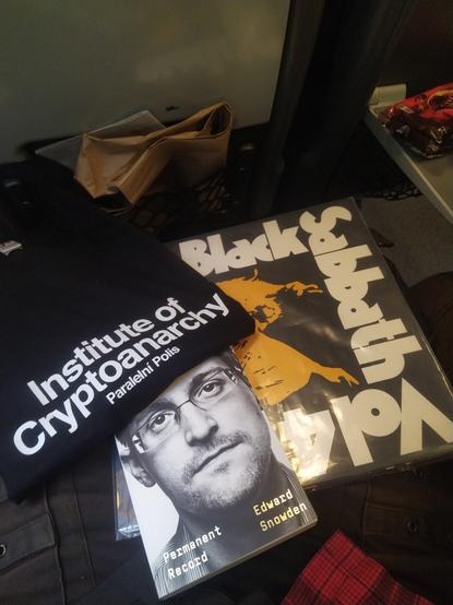 Picture of a T-shirt from Paralelní Polis, Snowden biography book, and Black Sabbath Vol. 4 vinyl