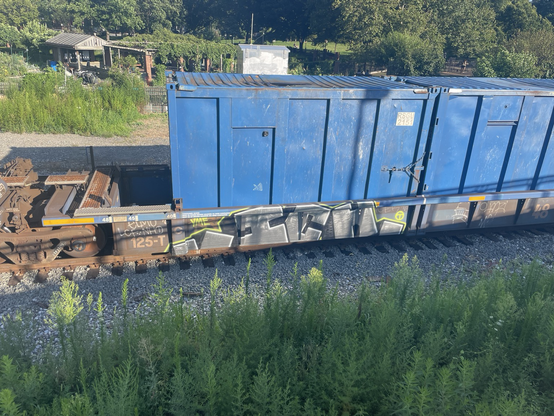 ICH graffiti on the bottom of a multi-modal freight car