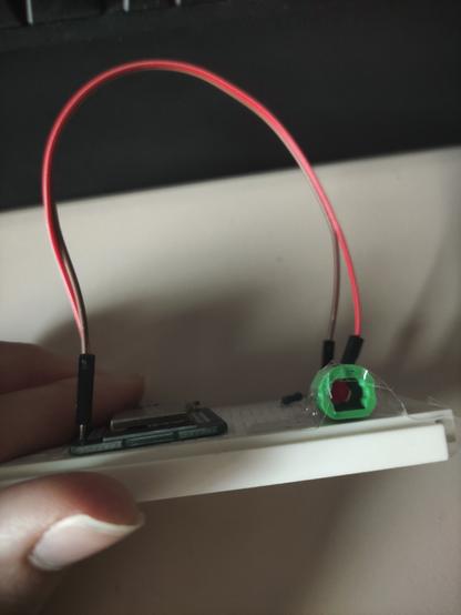 3d-printed toslink socket taped to a breadboard with a red led inside