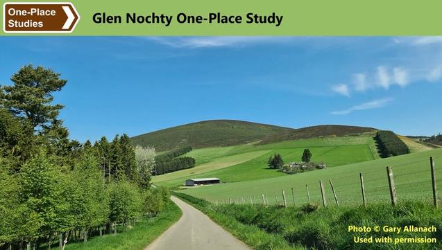 Society for One-Place Studies logo. Glen Nochty One-Place Study.
Photo: An unmarked, rural road runs through the middle of the picture. To the left are shrubs and trees. To the right are fields and low, rounded hills, with a couple of small conifer plantations and, near to the road, a barn.