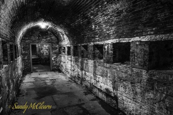 Underground passage with alcoves in the side walls.