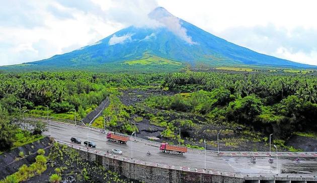 LAHAR PATH | Villages in areas identified as high-risk for lahar from Mayon Volcano are advised to be ready, especially during the typhoon season as heavy and continuous rains may generate lahar flows along major channels. This image of Mayon was taken from Barangay Mabinit in Legazpi City on July 21, 2023. (File photo by MARK ALVIC ESPLANA / Inquirer Southern Luzon)
