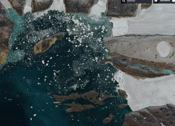 Satellite image of inner Inglefield Bredning, showing ocean water in shades of blue and green with white icebergs floating on top, glaciers discharging between greyish brown rocky mountains.