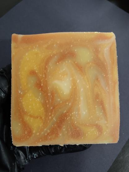 A copper, gold and cream colored soap bar