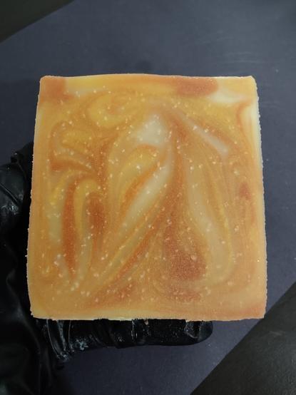 A copper, gold and cream colored soap bar