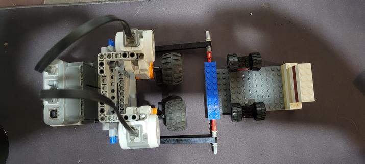 A top down photo of a lego mindstorms robotic contraption