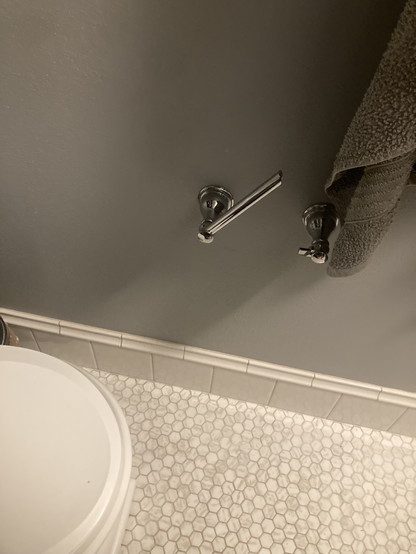 An empty toilet paper dispenser… again