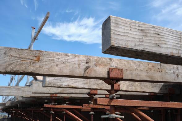 A set of wooden planks and rusty metal bars underneath a blue sky.