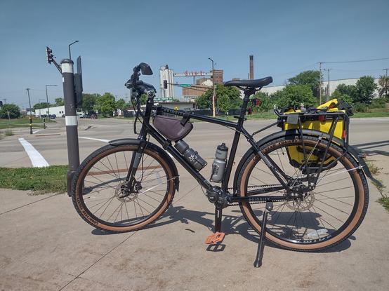 A bicycle on a trail in St Paul with the Schmidt brewing company building in the background