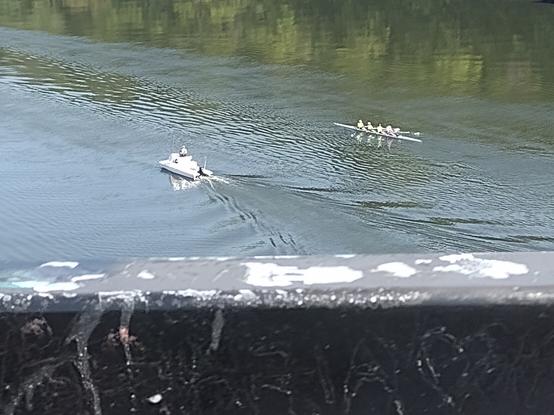 A view of the Mississippi river from a bridge with 6 man racing scull in the river on a training run