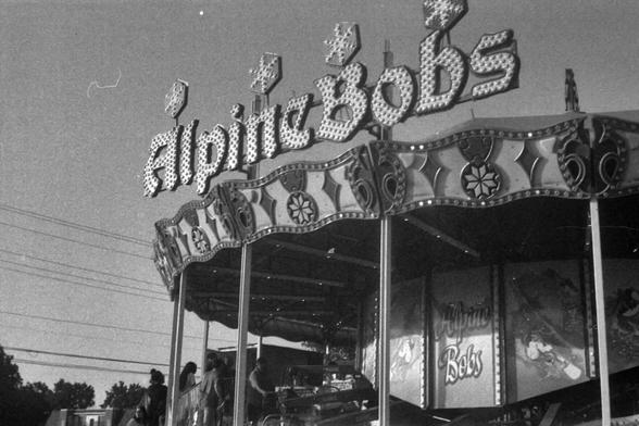 Black and white photograph of a carnival ride named "AlpineBobs"