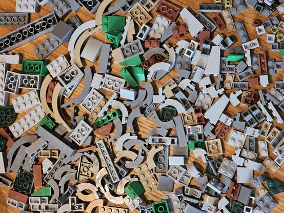 A wooden table with hundreds of building blocks filling the whole frame