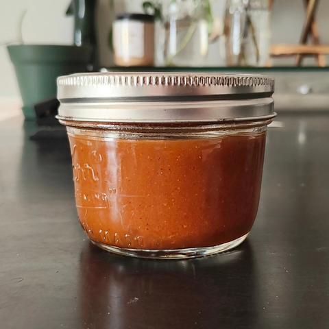 A small container of hot sauce