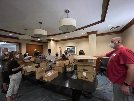 Volunteers for The Diana Initiative stuffing swag bags