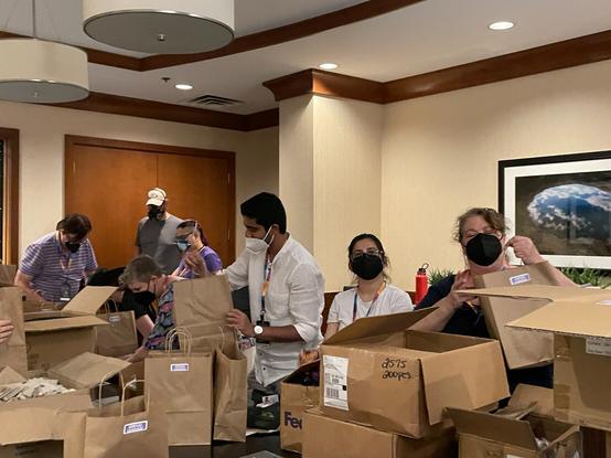 Volunteers for The Diana Initiative stuffing swag bags