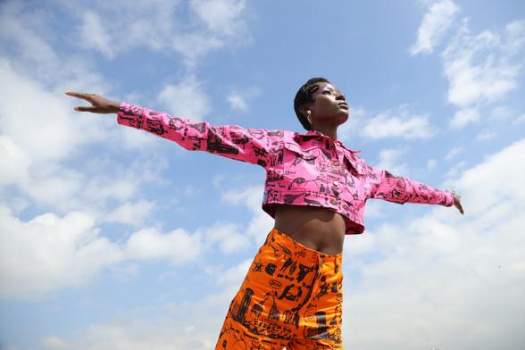 Model with arms outstretched, wearing Theresia Kyalo.