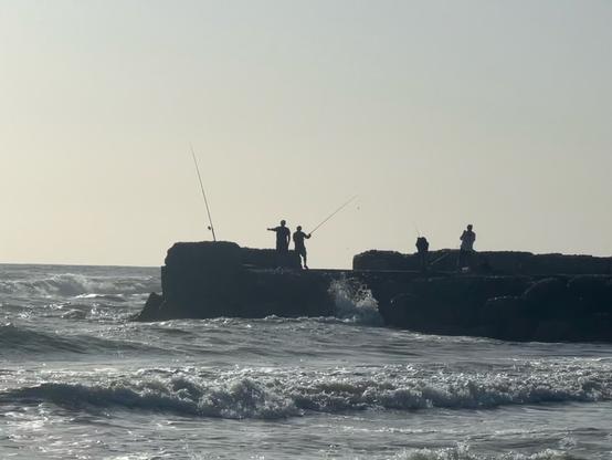 A group of fishermen on a stone quay at Sabaudia, Italy. The ocean was very rough.

A variation of this photo will be the new background image of my FishingKnots + app.