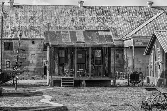 Small shack with rocking chairs on porch at the shack up inn, Clarksdale, Mississippi in black and white