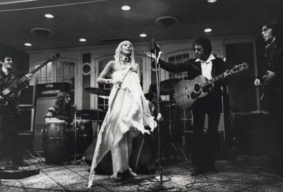 Uncropped photo of entire stage showing all musicians