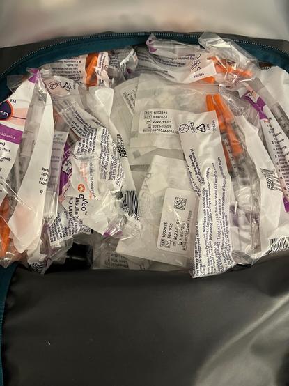 Photo shows a bag of syringes and computer pancreas supplies