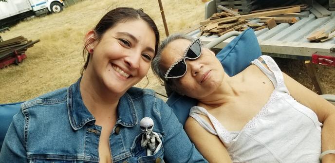 Gina, with alien figurine in her denim jacket left pocket. Mom's beside her; wearing my rhinestone cateye sunglasses.