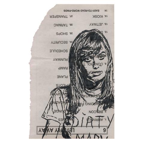 Pen drawing of a blonde woman wearing a T-shirt drawn on a torn-out crossword puzzle book page.