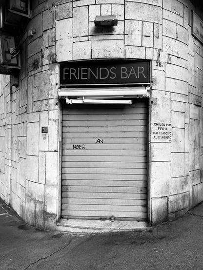 The entry of my favorite coffee bar in the neighborhood at Rome, Italy. The bar is closed for holiday as a notice besides the entry shows. I applied the iOS filter „Noir“ to the photo.