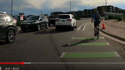 At 8:31 in the video, a good shot of the cross section relative to car widths, bike lanes with rubber parking stops and plastic sticks in the buffer, cars going two ways in under 20ft, probably keeps the speeds down!