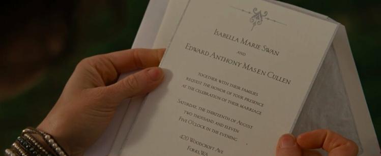 A wedding invitation. It reads: Isabella Marie Swan and Edward Anthony Masen Cullen, together with their families request the honor of your presence at the celebration of their marriage. Saturday, the thirteenth of August, two thousand and eleven, five o’clock in the evening, 420 Woodcraft Ave, Forks, Washington.”