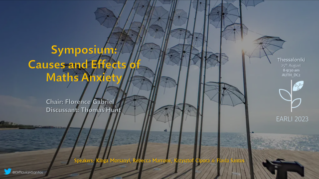 slide cover including the a post card photo from Thessaloniki a frame of umbrellas. it has the conference logo, speakers and symposium title