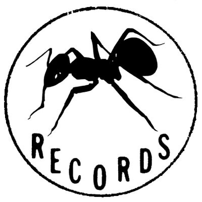 The Anticon logo, which is a simple black-and-white drawing of an ant inside a circle.