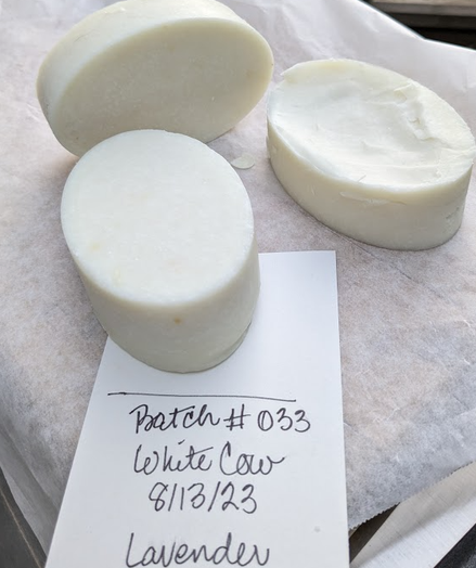 Three oval bars of white soap fresh from the mold.