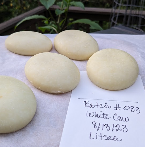 Five oval bars of whitish soap. These look like white stones or flattened eggs of some sort.