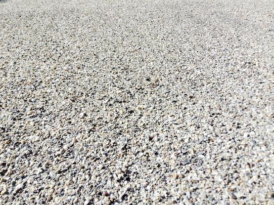 Closeup of the new surface. It's of light coloured stones, slightly loose.