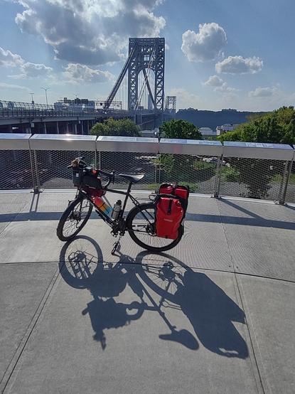A loaded touring bike in front of the George Washington Bridge.
