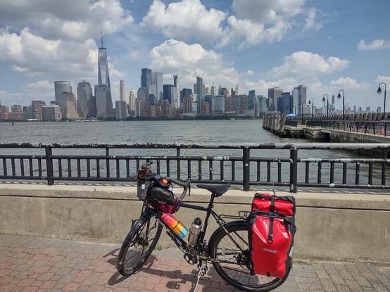 A loaded touring bike in front of the NYC skyline.