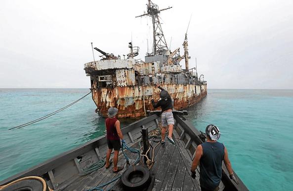 PRACTICALLY UNINHABITABLE | The decrepit BRP Sierra Madre, seen here being boarded by Philippine Navy men, may be in its last days, says Sen. Francis Escudero. He’s proposing the construction of a pier and lodging structures for Filipino soldiers stationed there, as well as for fishermen in distress. Photo taken on June 22, 2022. (Photo by MARIANNE BERMUDEZ / Philippine Daily Inquirer)