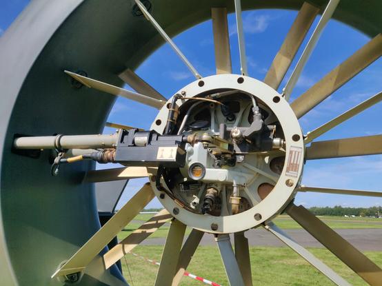 A ducted tailrotor of a helicopter without hub cover. Oil lines, cables and other delicate mechanical parts are exposed.